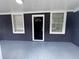Inviting screened porch with fresh paint, new windows, and outdoor lighting at 8018 Mulberry St, Tampa, FL 33604