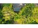 Aerial view of a home with mature trees and a screened-in pool at 803 Brooker Village Cir, Lutz, FL 33548