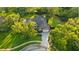 Aerial view of a well-maintained home with mature trees and landscaping at 803 Brooker Village Cir, Lutz, FL 33548