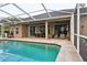 Inviting backyard with a pool, patio seating, lush landscaping, and a serene atmosphere at 803 Brooker Village Cir, Lutz, FL 33548