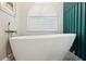Close-up of a soaking tub with white tiling and marble accents at 803 Brooker Village Cir, Lutz, FL 33548