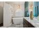A side view of the bathroom showing the marble countertop, soaking tub, and arched window at 803 Brooker Village Cir, Lutz, FL 33548