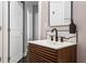 Bathroom featuring a modern vanity with wood trim, black faucet, and contrasting white countertop at 803 Brooker Village Cir, Lutz, FL 33548