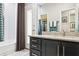 Bathroom with granite vanity, blue accents, and ample cabinet space with a door to the outside at 803 Brooker Village Cir, Lutz, FL 33548