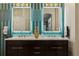 The bathroom has a marble countertop, dark wood cabinetry, and two lighted mirrors at 803 Brooker Village Cir, Lutz, FL 33548