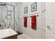 Modern bathroom featuring white marble-style tile shower with glass doors and a wall mounted rack at 803 Brooker Village Cir, Lutz, FL 33548