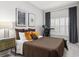 Bedroom with a treadmill, plantation shutters, neutral walls and brown and gold bedding at 803 Brooker Village Cir, Lutz, FL 33548