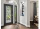 Foyer with decorative front door, wood floors, and niche with display items at 803 Brooker Village Cir, Lutz, FL 33548