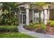 Close-up of front door with decorative glass and landscaped walkway at 803 Brooker Village Cir, Lutz, FL 33548