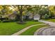 Charming home with a lush front yard and a circular driveway at 803 Brooker Village Cir, Lutz, FL 33548