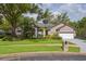 Beautiful single-story home with lush landscaping, two-car garage, and well-manicured lawn at 803 Brooker Village Cir, Lutz, FL 33548