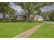 Charming single-story home with well-maintained lawn and mature trees at 803 Brooker Village Cir, Lutz, FL 33548