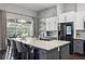 Modern kitchen with a large island, granite countertops, stainless steel appliances, and seating for casual dining at 803 Brooker Village Cir, Lutz, FL 33548
