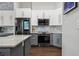 Well-equipped kitchen featuring stainless steel appliances, granite countertops, and modern cabinets for a contemporary design at 803 Brooker Village Cir, Lutz, FL 33548