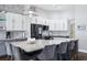 Stylish kitchen featuring a spacious island, sleek countertops, stainless steel appliances, and ample cabinet space at 803 Brooker Village Cir, Lutz, FL 33548