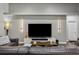 Modern living room with a large television, sleek entertainment center, and stylish decor creating a cozy ambiance at 803 Brooker Village Cir, Lutz, FL 33548