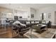 Open-concept living room flowing into the kitchen, featuring chic decor and a seamless transition for modern living at 803 Brooker Village Cir, Lutz, FL 33548