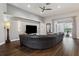 Spacious living room with large leather sofa, modern lighting, and sliding glass doors at 803 Brooker Village Cir, Lutz, FL 33548