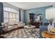 Stylish living room with large window, shutters, and contemporary furnishings at 803 Brooker Village Cir, Lutz, FL 33548