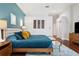 A view of the the spacious main bedroom with an accent wall, hardwood floors, and a closet at 803 Brooker Village Cir, Lutz, FL 33548
