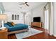 This light and airy main bedroom has hardwood floors and features a ceiling fan and sliding glass door at 803 Brooker Village Cir, Lutz, FL 33548