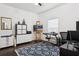 Bright office space featuring a desk, shelving unit, and painting easel, perfect for a creative workspace at 803 Brooker Village Cir, Lutz, FL 33548