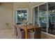 Inviting outdoor patio with wood table, seating, and views of the pool through large sliding glass doors at 803 Brooker Village Cir, Lutz, FL 33548
