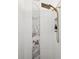 This shower has white tiling with a decorative marble stripe and a gold shower head at 803 Brooker Village Cir, Lutz, FL 33548