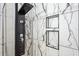 Contemporary shower with white tile, black accents, and built-in niche for toiletries at 803 Brooker Village Cir, Lutz, FL 33548