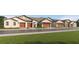 Charming townhome exterior featuring multiple units, attached garages, and manicured lawns at 8466 Course Br, New Port Richey, FL 34655