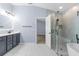 Bathroom featuring double vanity with modern fixtures, a walk-in glass shower and soaking tub at 8836 Alafia Cove Dr, Riverview, FL 33569