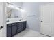 Bathroom featuring a double vanity, modern fixtures and a backlit mirror at 8836 Alafia Cove Dr, Riverview, FL 33569
