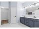Bathroom featuring double vanity with modern fixtures and a separate door to the walk-in closet at 8836 Alafia Cove Dr, Riverview, FL 33569