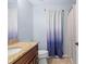 Well-lit bathroom featuring a vanity with granite countertop and shower with curtain at 8836 Alafia Cove Dr, Riverview, FL 33569
