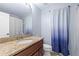 Bathroom featuring a granite countertop vanity and a blue-ombre shower curtain at 8836 Alafia Cove Dr, Riverview, FL 33569
