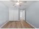 Open bedroom with wood-look floors, ceiling fan, and closet at 8836 Alafia Cove Dr, Riverview, FL 33569