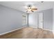 Empty bedroom featuring wood-look floors and a ceiling fan at 8836 Alafia Cove Dr, Riverview, FL 33569
