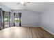 Large bedroom showcasing wood-look floors, a large window and sliding glass doors at 8836 Alafia Cove Dr, Riverview, FL 33569