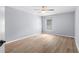 Bright bedroom with wood-look floors, ceiling fan, and a window with blinds at 8836 Alafia Cove Dr, Riverview, FL 33569