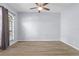 Spacious bedroom featuring hardwood floors, a modern ceiling fan and a large window at 8836 Alafia Cove Dr, Riverview, FL 33569