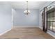 Hardwood dining room area with decorative chandelier and window providing natural light at 8836 Alafia Cove Dr, Riverview, FL 33569