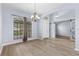 Dining Room area showcasing hardwood floors, chandelier, and view into the foyer and living room at 8836 Alafia Cove Dr, Riverview, FL 33569