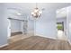 Spacious dining room area with hardwood floors that leads to the foyer, kitchen and living room at 8836 Alafia Cove Dr, Riverview, FL 33569