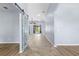 Bright foyer featuring tile flooring and a decorative barn door leading to an adjacent room at 8836 Alafia Cove Dr, Riverview, FL 33569