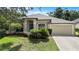 Beautifully landscaped one story home with a manicured lawn and attached two car garage at 8836 Alafia Cove Dr, Riverview, FL 33569
