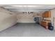 Clean garage featuring epoxy floors, storage space, and an automatic door at 8836 Alafia Cove Dr, Riverview, FL 33569