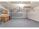 Spacious garage with epoxy floors, storage cabinets, and an automatic door at 8836 Alafia Cove Dr, Riverview, FL 33569
