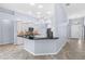 Bright, open kitchen featuring white cabinets and black granite countertops with stainless appliances at 8836 Alafia Cove Dr, Riverview, FL 33569