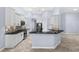 Modern kitchen features white cabinets, black granite countertops, and stainless steel appliances at 8836 Alafia Cove Dr, Riverview, FL 33569