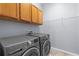 Laundry room with washer, dryer, wire shelving, and overhead cabinets at 8836 Alafia Cove Dr, Riverview, FL 33569